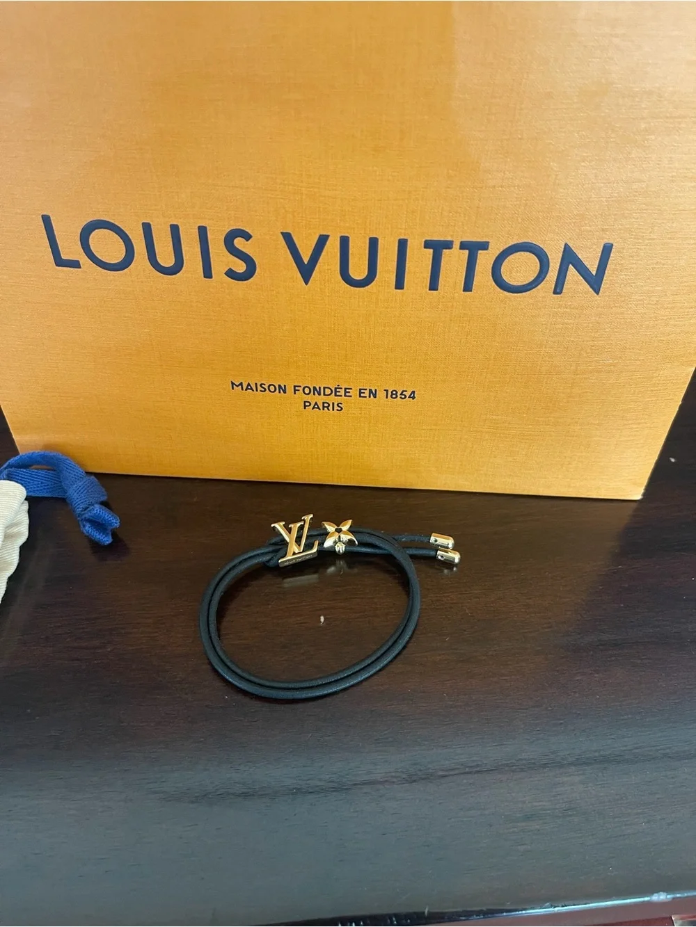 Louis Vuitton Blossom Black Cord Bracelet with Gold LV and Flower. Adjustable.
